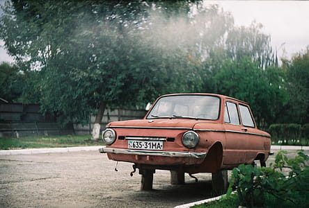 Abandoned Red Car Parked On Side Of Road thumbnail