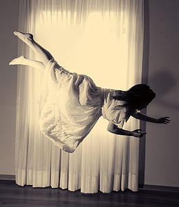 woman wearing white dress floating in the air thumbnail