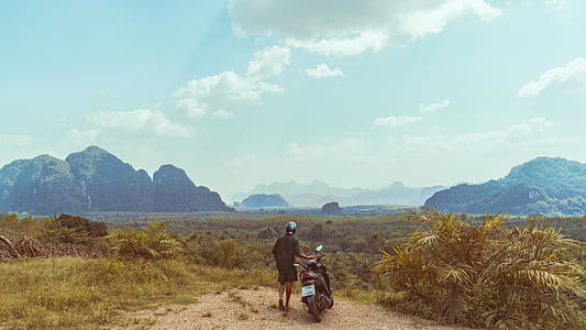 person holding black automatic scooter thumbnail