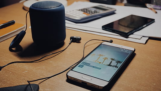 white smartphone on wooden desk thumbnail