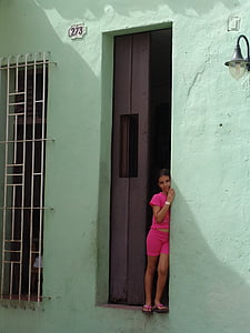 girl leaning on green painted wall thumbnail