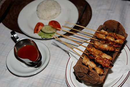 barbecue on tray beside plate with rice thumbnail