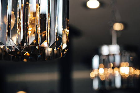 Elegant black designer chandelier with a lit lightbulb thumbnail