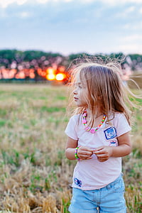 girl standing on grass at daytime thumbnail