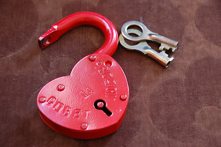 selective focus photo of red padlock with key on surface thumbnail