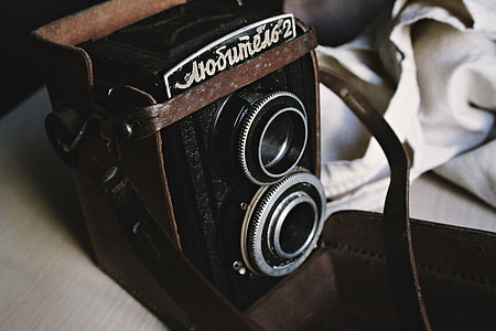 black and grey camera near grey textile thumbnail