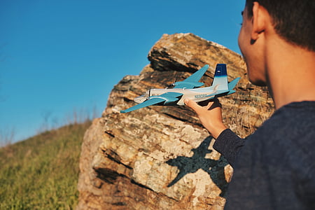 boy holding toy plane thumbnail
