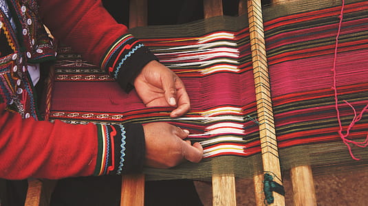 person wearing long-sleeved top doing textiles thumbnail
