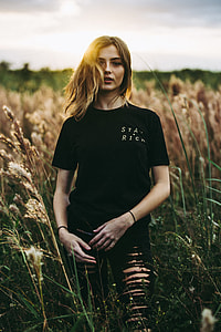 woman in black crew-neck t-shirt standing on wheat field thumbnail