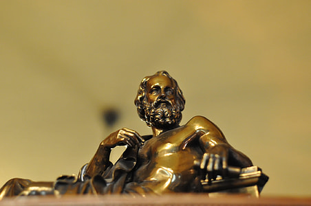 low angle photography of man figurine thumbnail