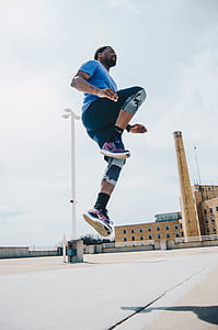 man jumping on concrete pavement thumbnail