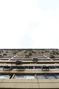 worm view photography of brown high-rise building thumbnail