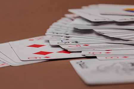 assorted playing card lot on brown sooden surface thumbnail