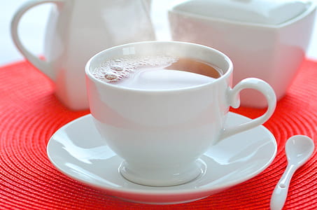 white ceramic cup filled with brown liquid thumbnail