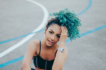 woman wearing black sport bra and holding her hair thumbnail