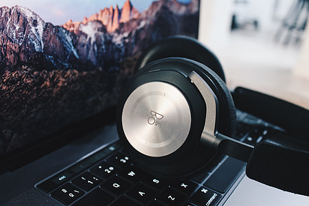 silver and black headphones on laptop thumbnail