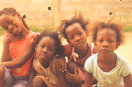 photography of children sitting in front of concrete wall thumbnail