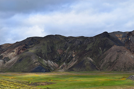 landscape photography of mountain with grass field thumbnail