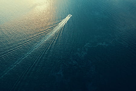 Aerial Photography of Boat on Calm Sea thumbnail
