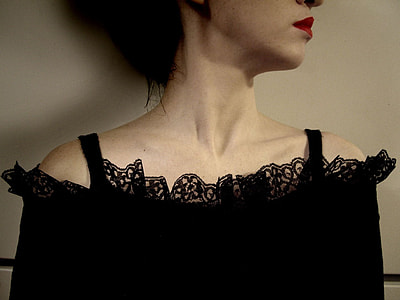 woman wearing black spaghetti strap top in room thumbnail