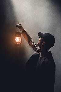man holding up a lantern thumbnail