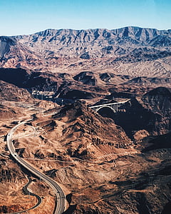 panoramic photo of rock formation with winding road thumbnail