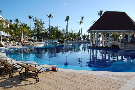 brown lounger near blue swimming pool on swimming resort during daytime thumbnail