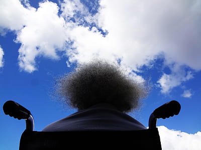 low angle photography of person sitting in the wheelchair while watching the sky thumbnail