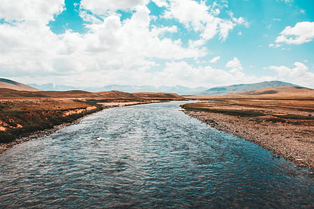 river running through mountains and hills thumbnail