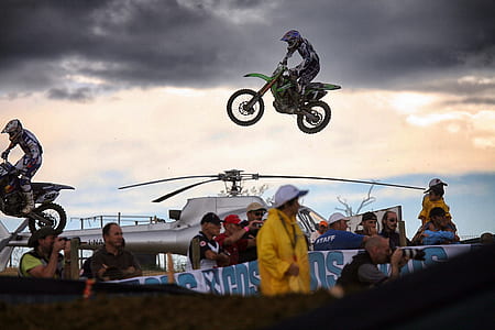 person doing dirt motorcycle trick over helicopter thumbnail