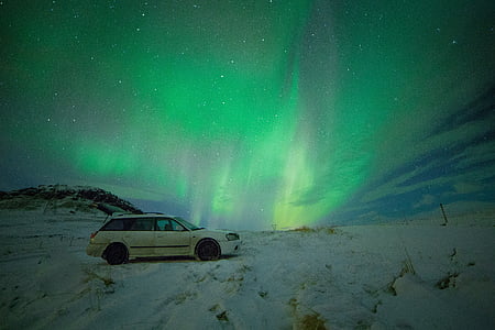 white station wagon during northern lights thumbnail