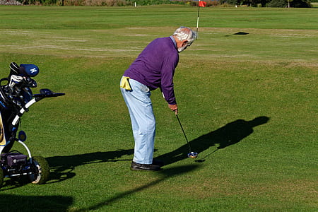 person holding golf club thumbnail