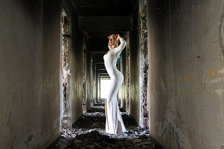 woman with white long-sleeved bodycon slit maxi dress standing on hallway thumbnail