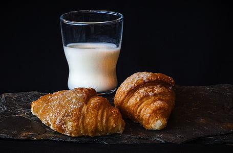 clear drinking glass with milk beside the bread thumbnail
