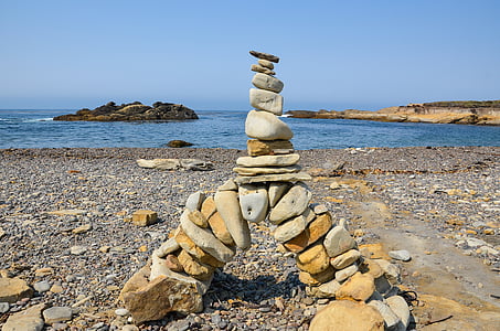 brown and gray balance stone at shore thumbnail