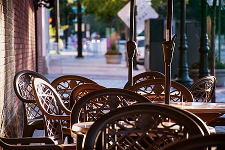 Brown Wooden Table Surrounded With Chairs thumbnail