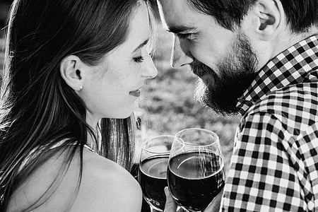 grayscale photography of man and woman holding beverage thumbnail