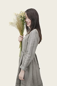 woman wearing long-sleeved dress holding bouquet of flower thumbnail