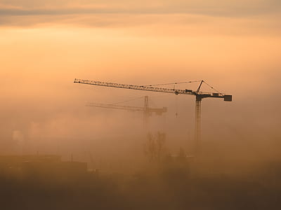 black metal crane covered in fog during daytime thumbnail