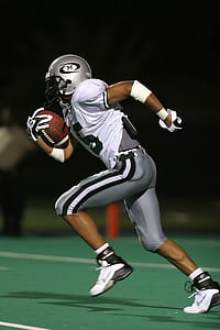 Football Player Holding Football thumbnail