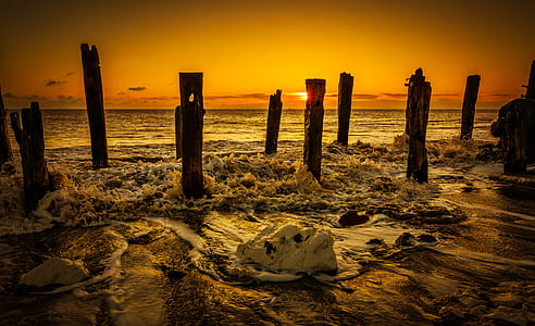 silhouette of post on seashore thumbnail