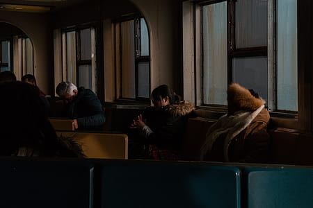 woman wearing coat sitting on sofa thumbnail