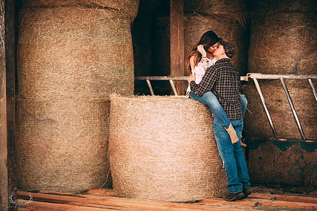 man and woman kissing on hay thumbnail