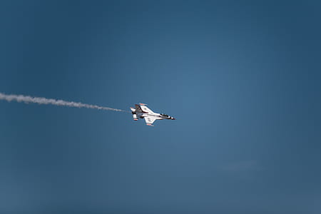 white fighter jet flying in the sky thumbnail
