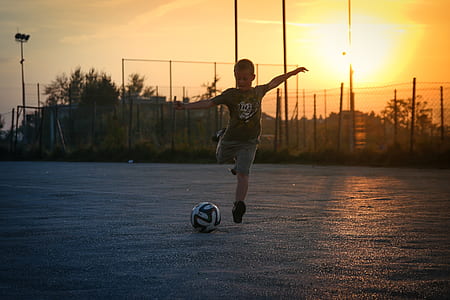 boy about to kick on blue ball thumbnail