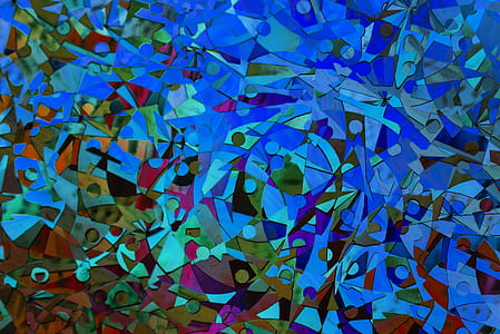 Close up of abstract colorful glass mosaic created by cutting glass pieces into various shapes and sizes thumbnail