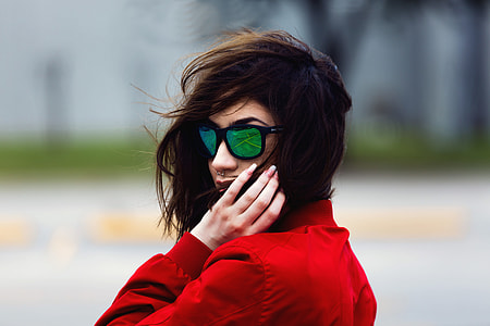 Portrait of woman with long hair wearing sunglasses thumbnail