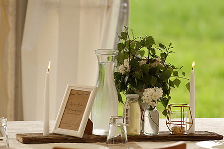 clear glass jar and vase on table surface thumbnail