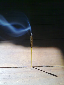 brown and gray incense stick lighted with smoke thumbnail
