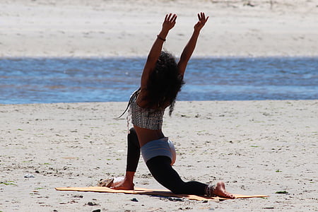 photo of woman wearing gray top kneeling on brown sand during daytime thumbnail